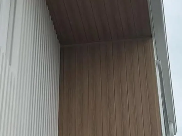 Woodgrain aluminium boards lining a recessed entry wall and soffit