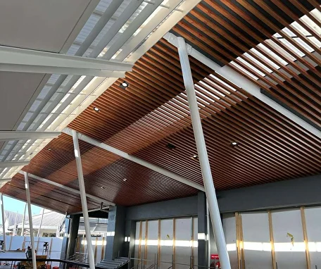 Woodgrain aluminium battens lining an outdoor ceiling