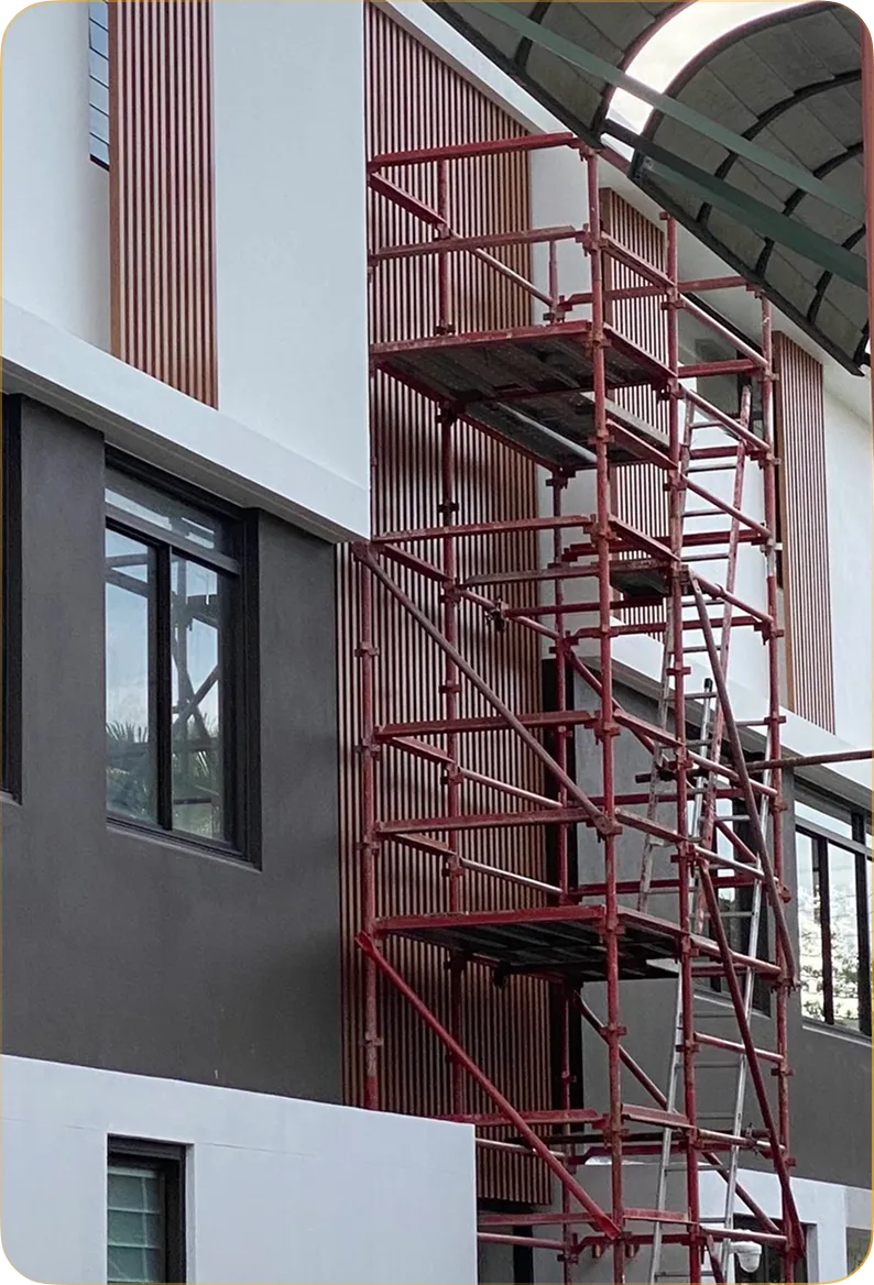 Scaffold tower against a two-storey facade during batten installation