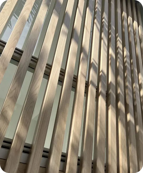 Woodgrain aluminium cladding running across a building facade