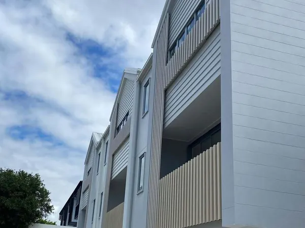 Townhouse balconies screened with vertical woodgrain aluminium battens